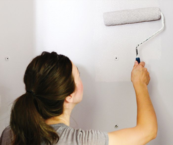 woman painting wall.