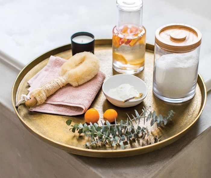 Clear Glass Carafe, Mercer 5 inch Mini Bowl, Turkish Cotton Washcloth, and Faux Eucalyptus Bunch, All Sitting on a Element Metal Antiqued Pewter Tray.