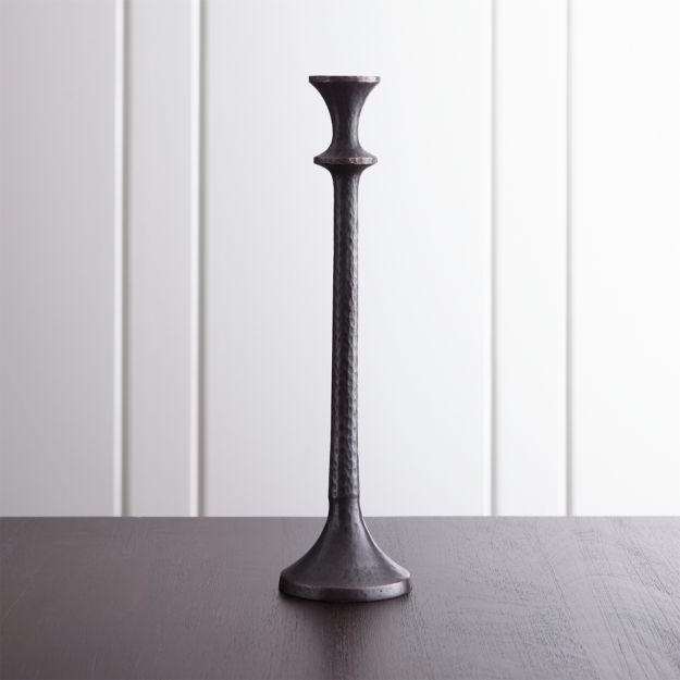 A textured finish and a warm antique bronze finish impart a rustic look to this classically shaped candle holder. Stately large holder pairs beautifully with smaller sizes in the Emmett collection.