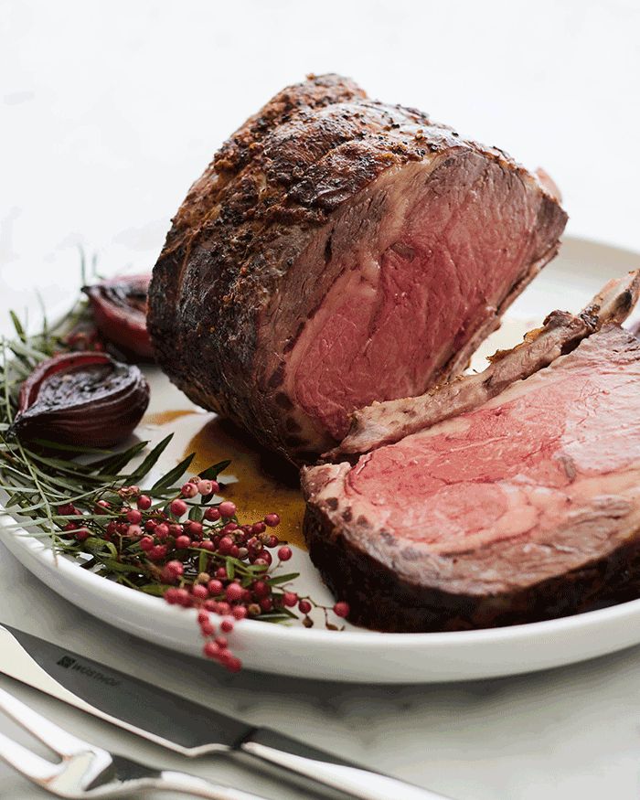 Sliced Roasted Prime Rib With Knife On Plank Stock Photo