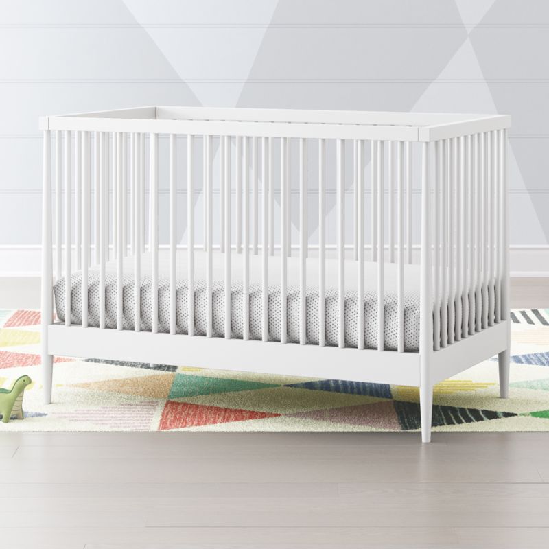 white crib with wood x on side