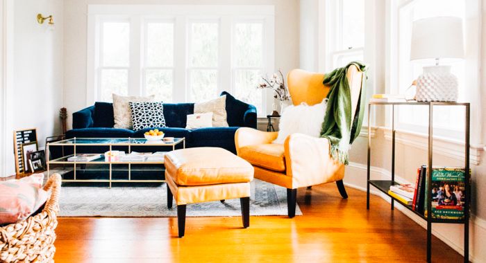 Living room with a blue sofa and a Garbo Leather Wingback Chair