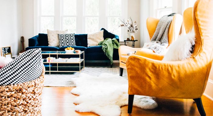 Living room with a blue sofa and a Garbo Leather Wingback Chair