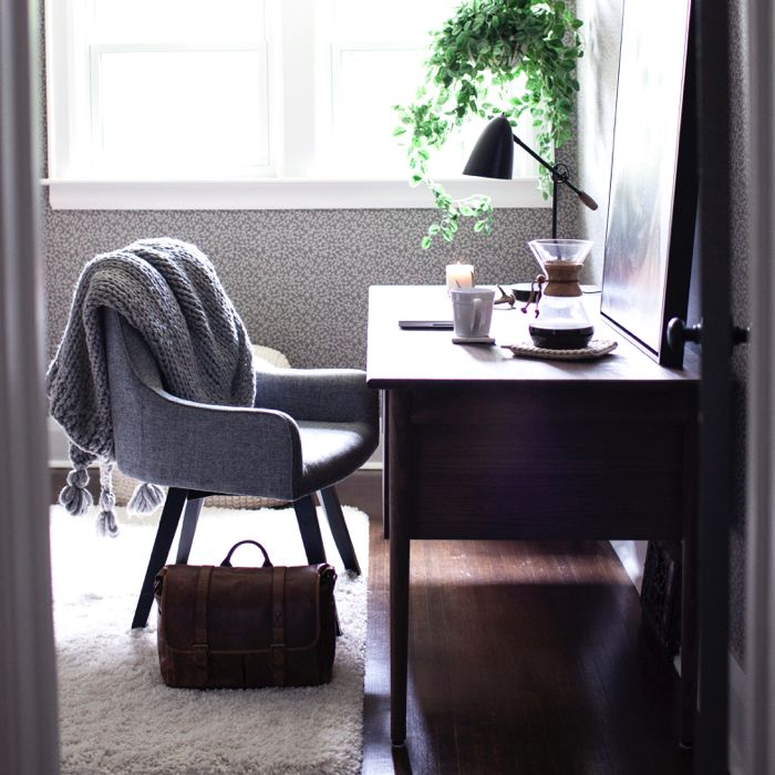 Home office with a brown desk and a gray chair.