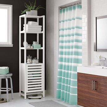 Bathroom with a striped shower curtain and storage shelf.