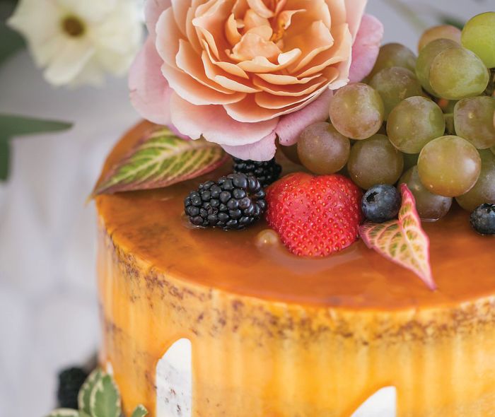 Cake decoration with flowers and fruit.