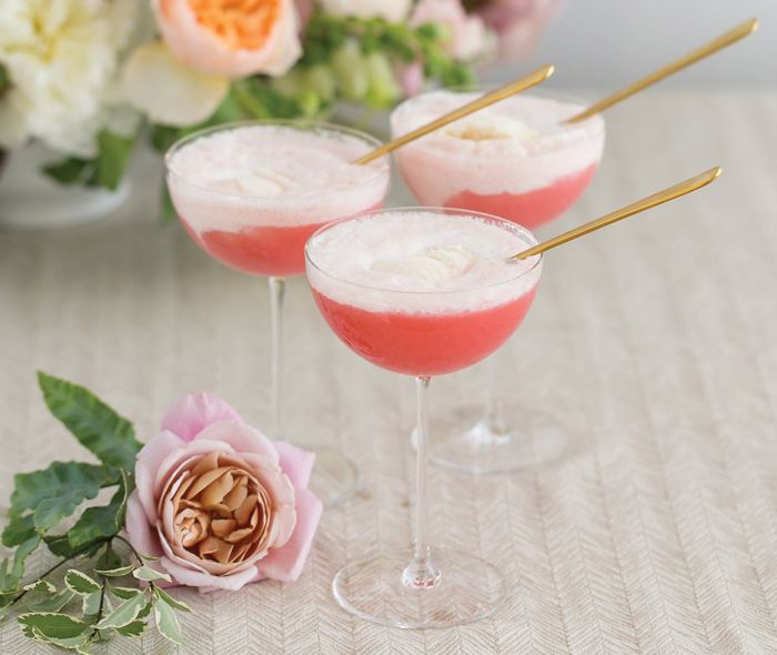 Pink cocktail with a gold spoon.