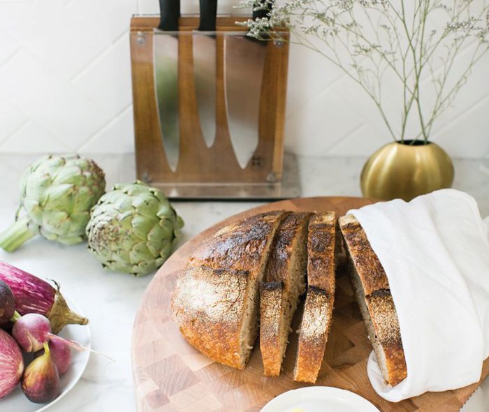 A John Boos Maple Cutting Board and a Schmidt Brothers® 7-Piece Carbon 6 Knife Block Set