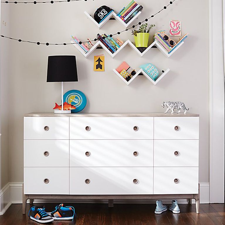 White dresser with black table lamp and tiger figurine on top