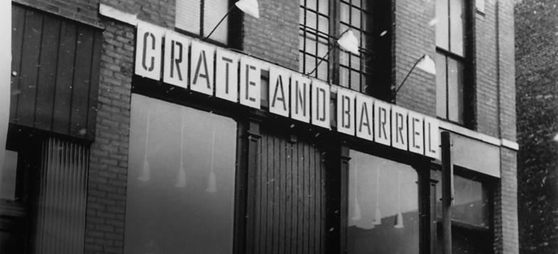 a warehouse building with crate and barrel signs on top 