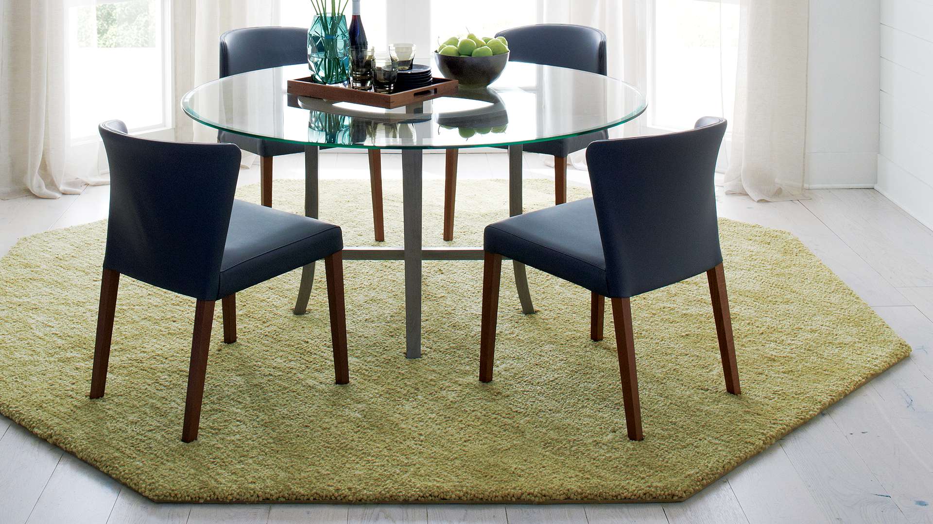 Curran dining chairs and halo grey dining table on top of a green octagonal custom made rug.