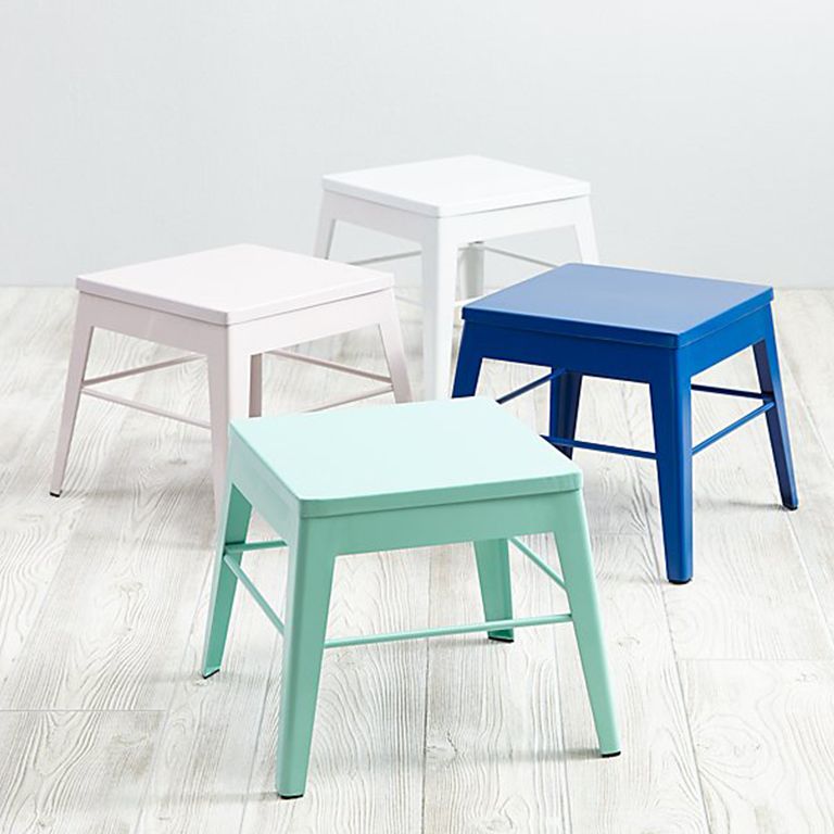 Four metal step stools in various colors