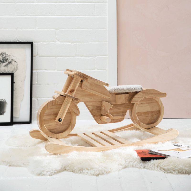 Close up of wooden motorcycle rocking toy from the Leanne Ford collection