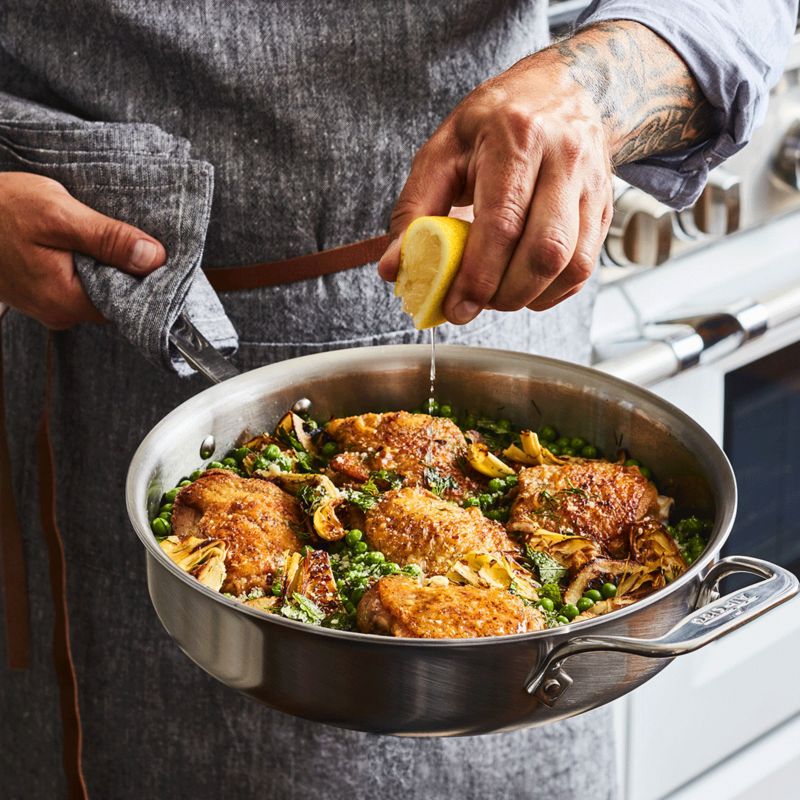 Chicken with artichoke hearts and peas in a pan