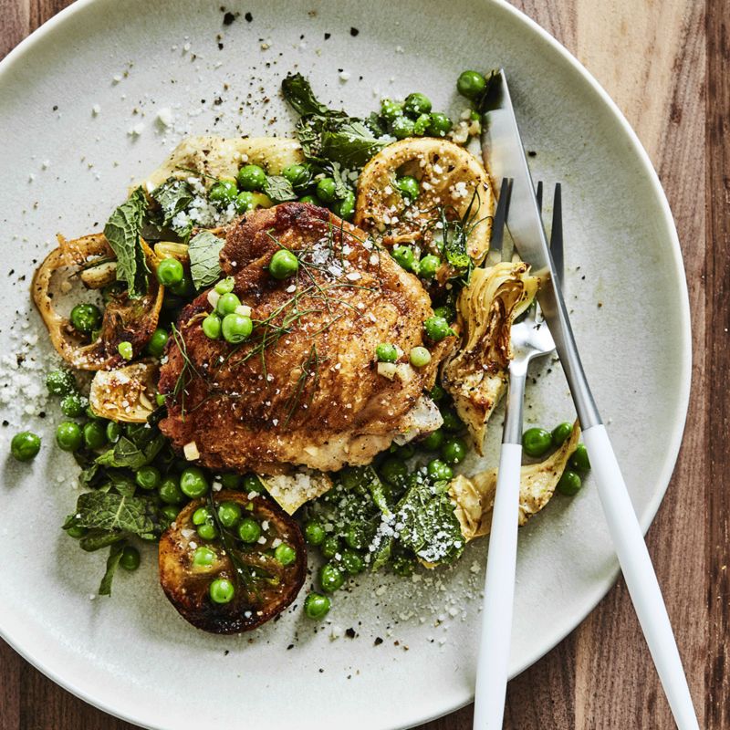 Chicken with artichoke hearts and peas in a pan