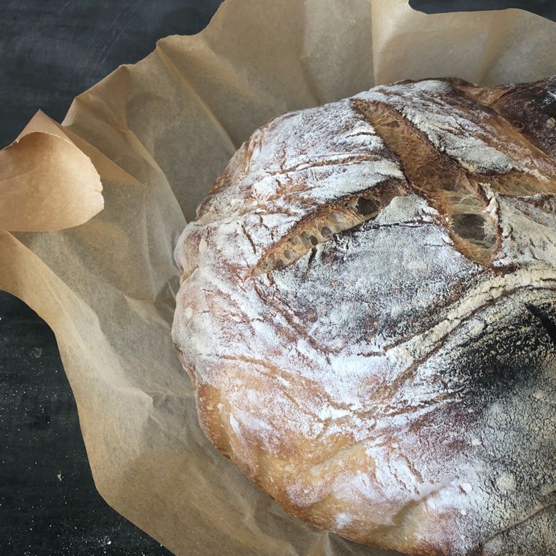 Baking Loaf of Bread Flour Product in a Nest on a Wooden Table