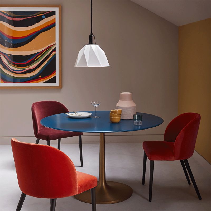 Dining space featuring Daniel Barreto painting and three-seated dining table