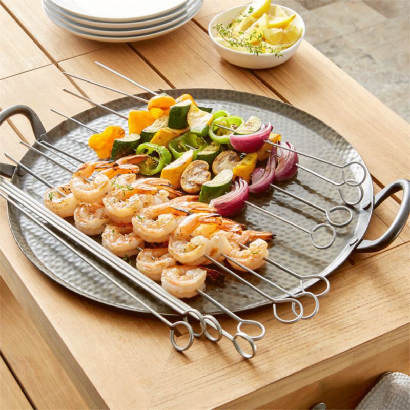 Shrimp and vegtable skewers on metal serving tray