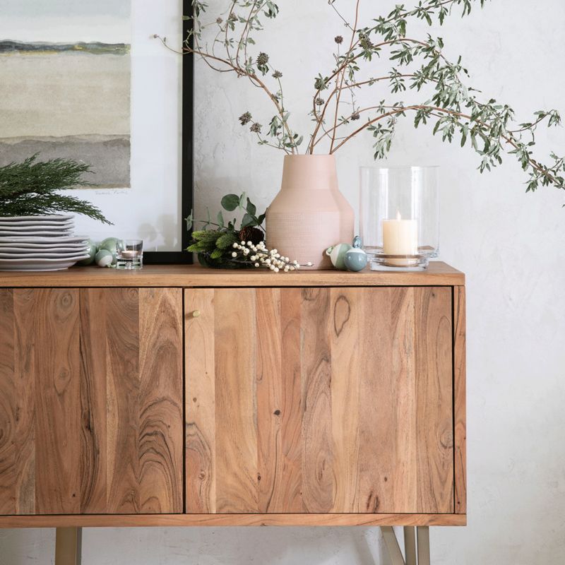 Wooden credenza with holiday greenery decor