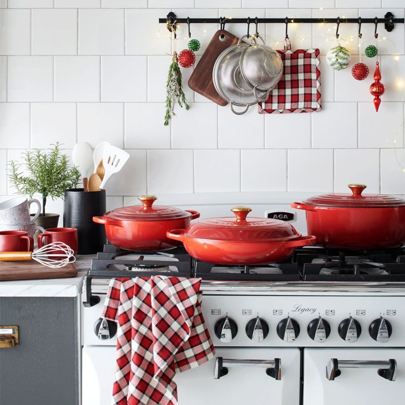 Red Le Creuset cookware and holiday kitchen decor