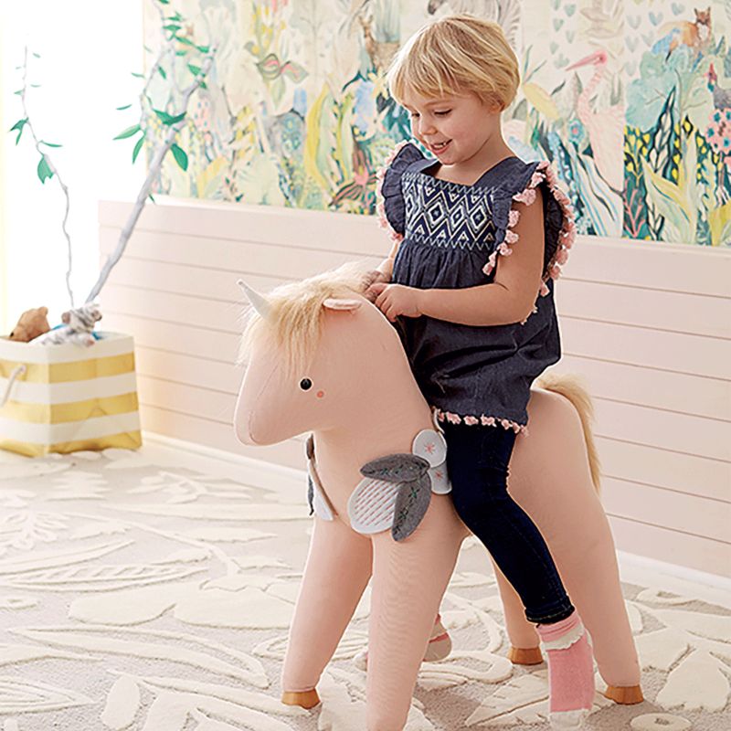 Girl on pink unicorn rocker