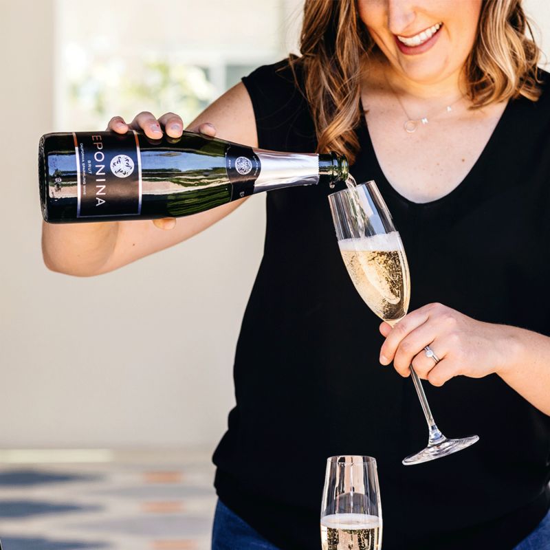 Woman pouring champagne into glass