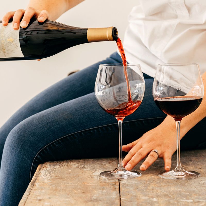 Woman pouring red wine into glass