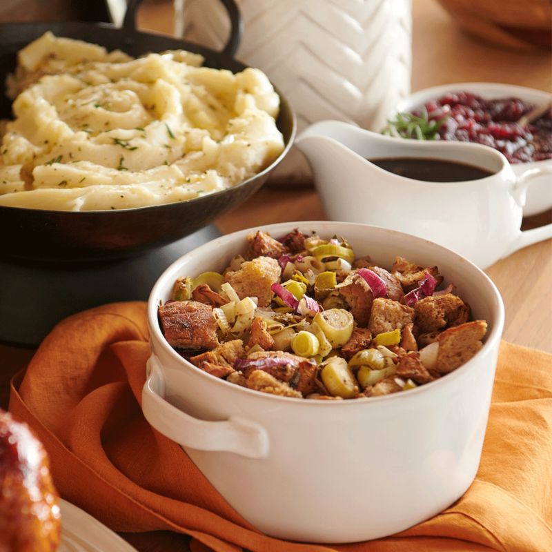 Thanksgiving stuffing and mashed potatoes in holiday cookware