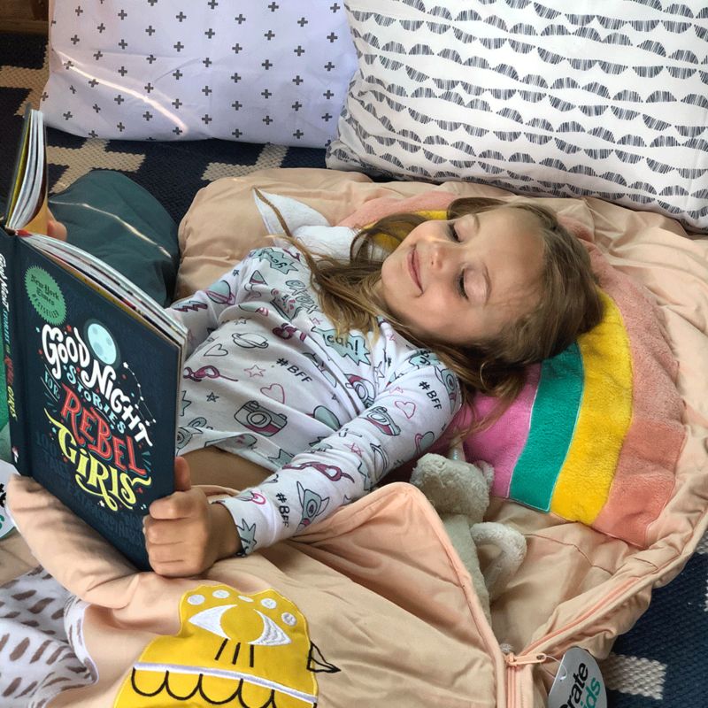 Girl reading a book in sleeping bag