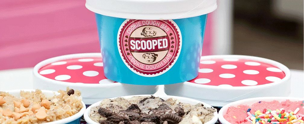 Colorful containers of edible cookie dough from Scooped Cookie dough bar