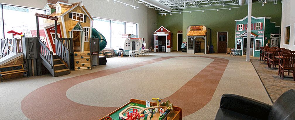 Large playroom with playhouses at the Little Beans Cafe