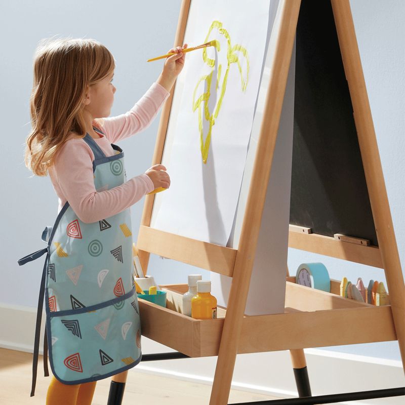 Young girl painting on easle