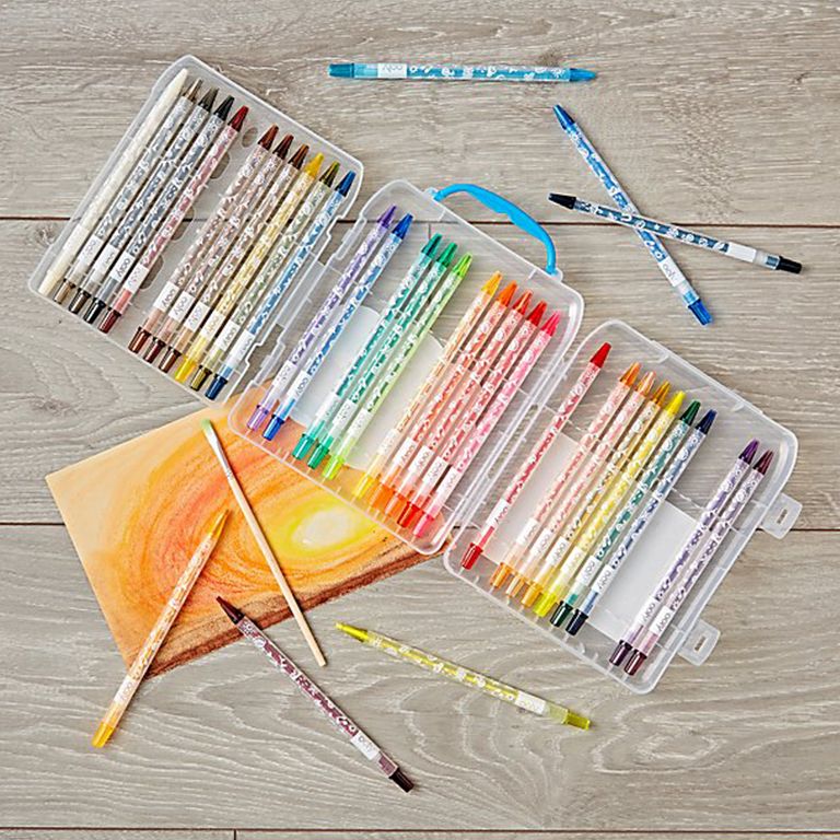 Twistable colored pencil set next to a drawing of a sunrise