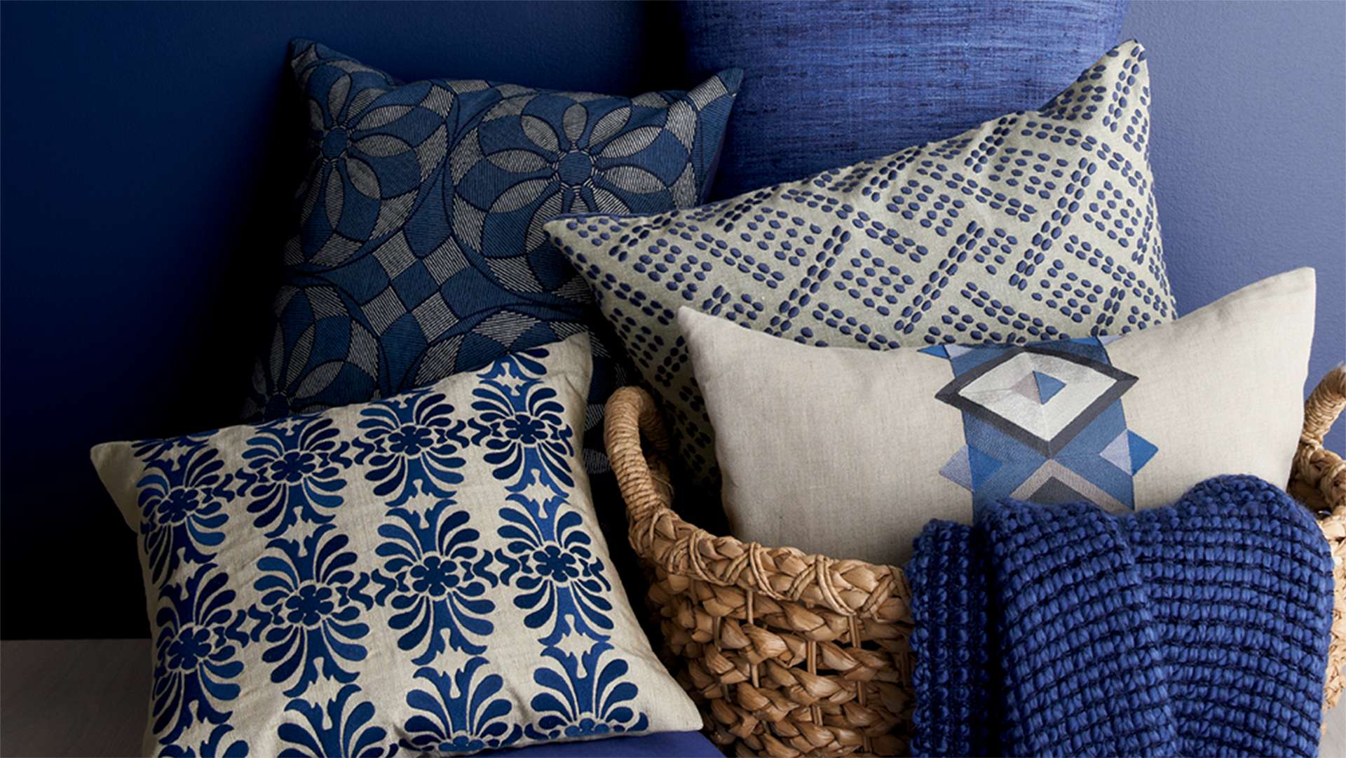Blue pillows and throws in a basket