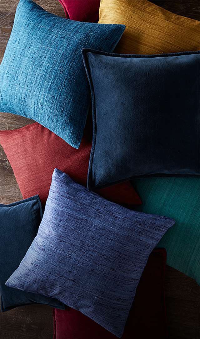 pile of jewel toned pillows